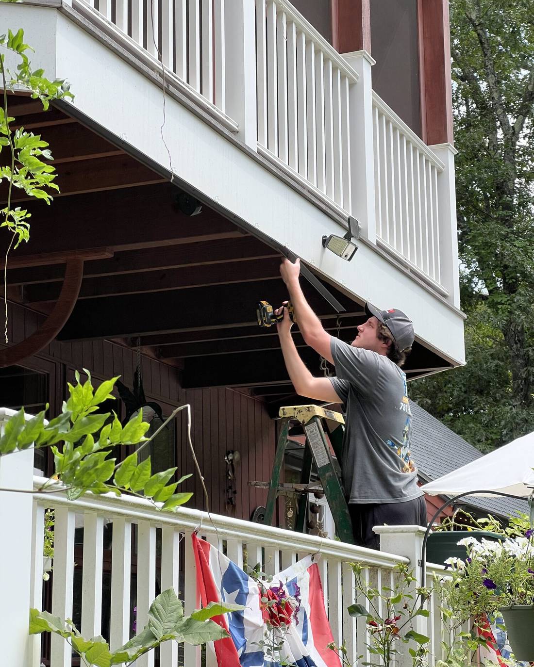 Seasons Shining technician installing outdoor deck lighting