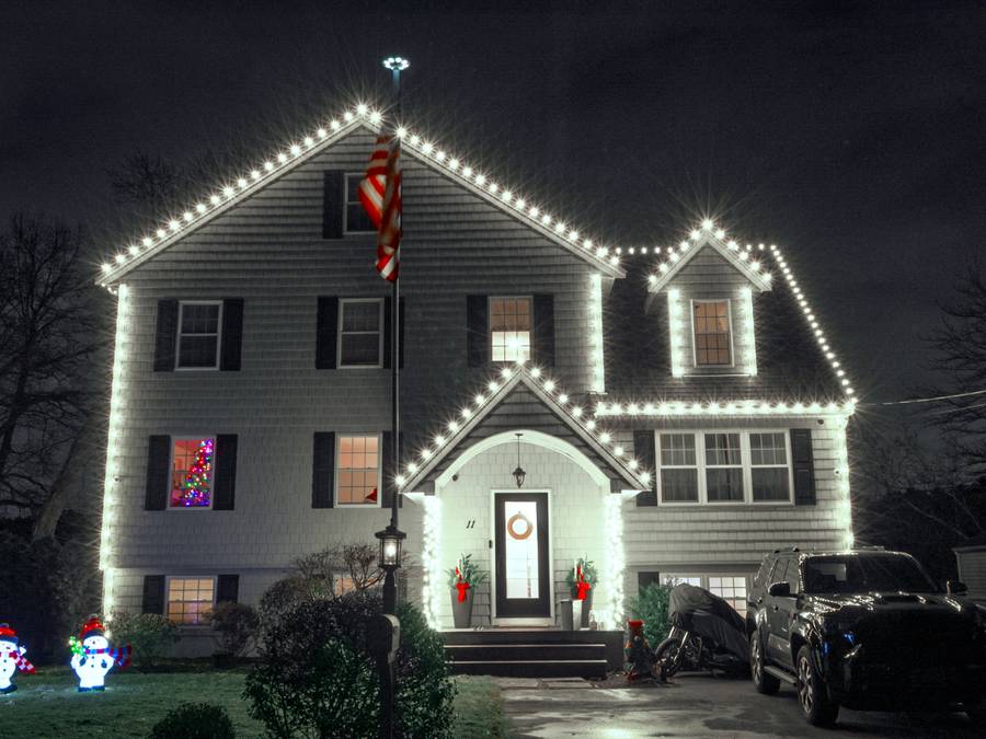 Christmas light installation on a front walkway and entry