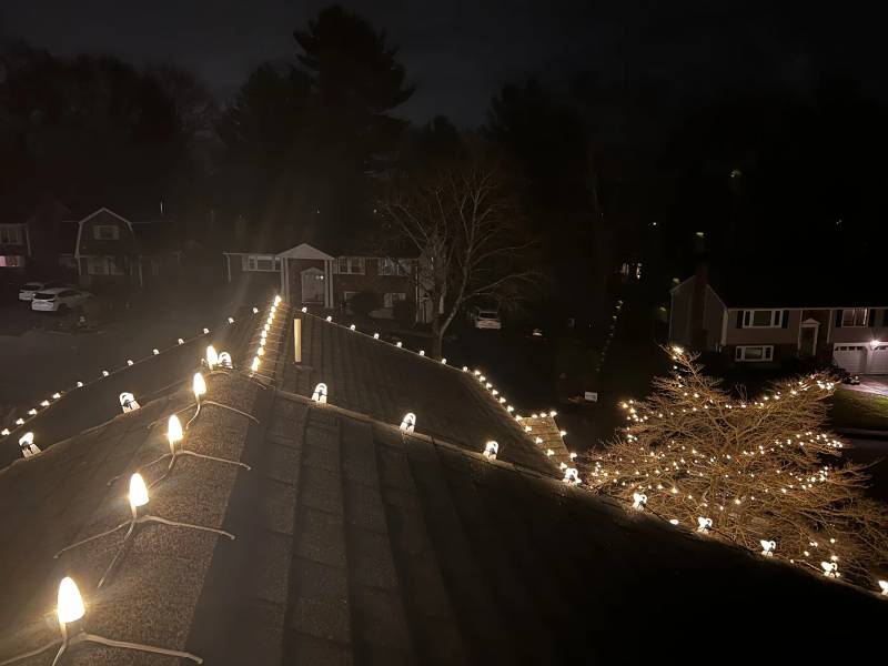 Holiday bulbs following the roof ridges at night