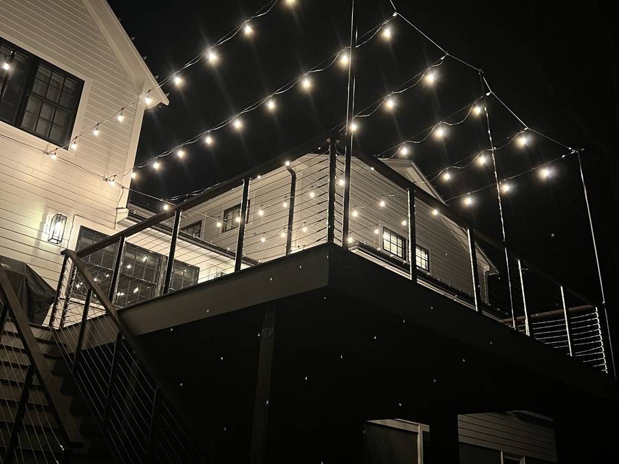 Warm cafe string lights above a residential patio