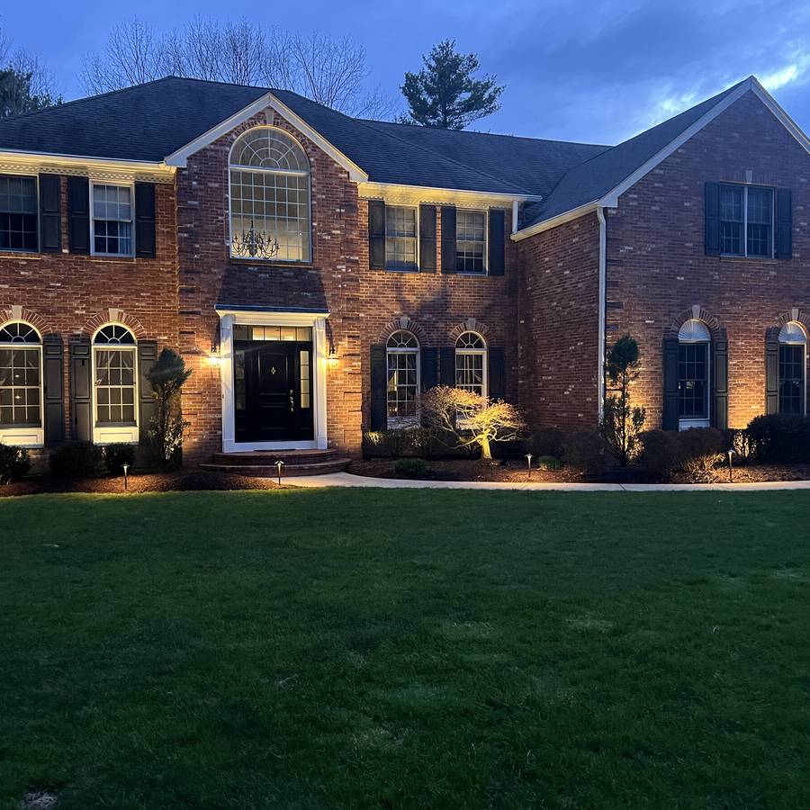 Architectural lighting on a brick home at dusk