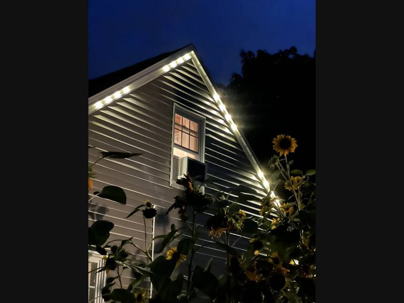 Warm white permanent LEDs illuminating a gable at night