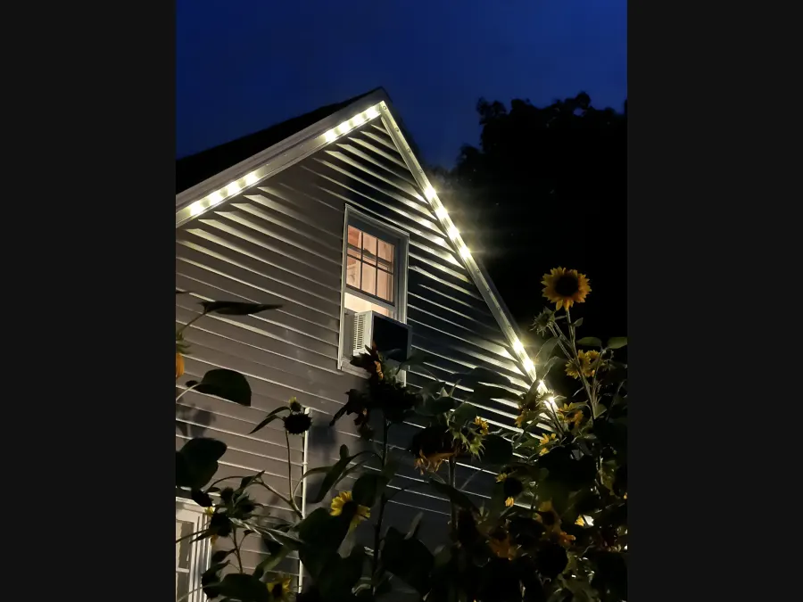 Warm white permanent LEDs illuminating a gable at night