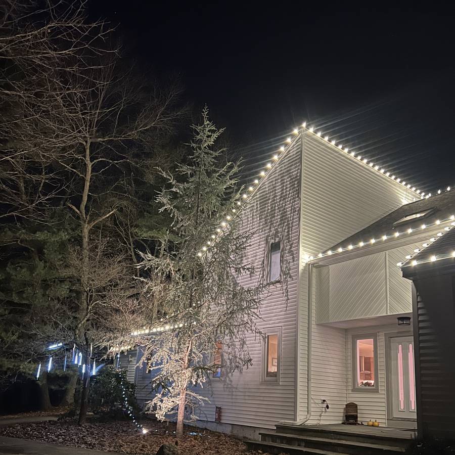 Warm white entry and roofline lights on a Sharon home