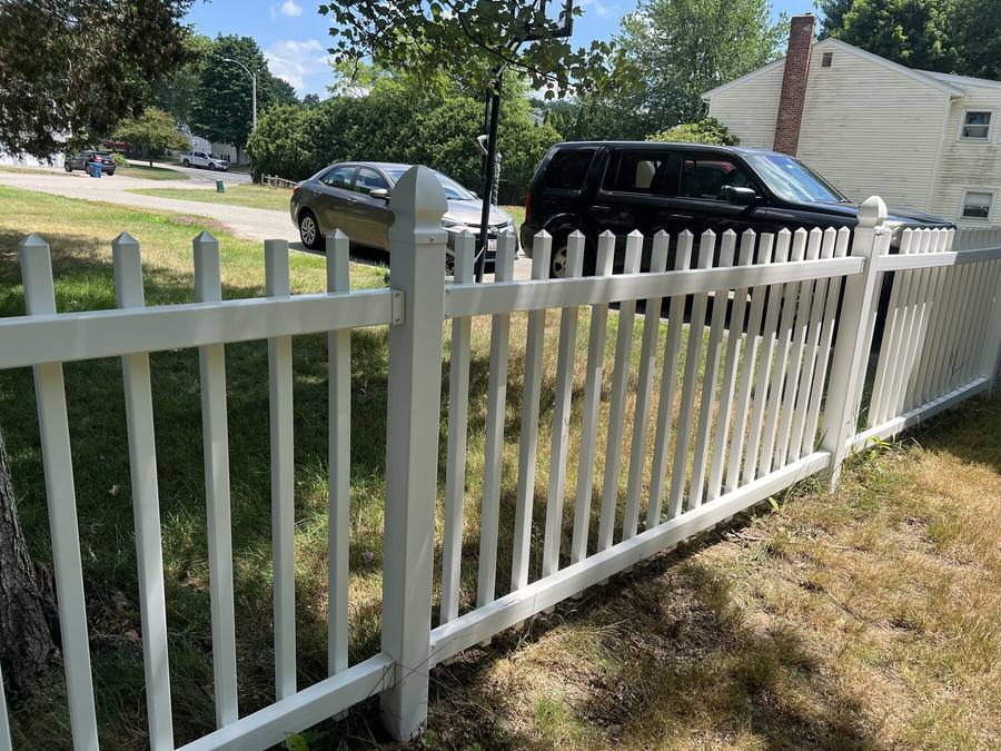 Vinyl fence after soft washing with a clean white finish